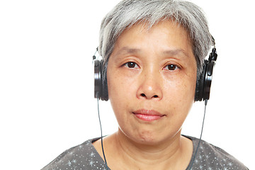 Image showing mature woman listen music