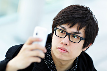 Image showing young man taking picture with mobile phone