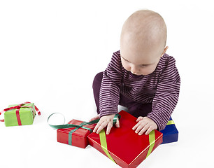 Image showing young child unpacking presents