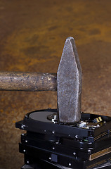 Image showing hammer on stack of hard disk