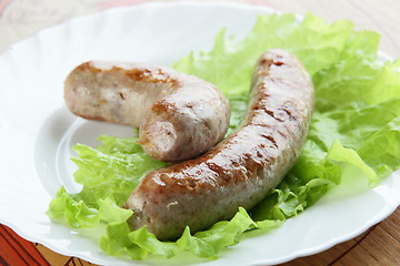 Image showing two sausages on plate