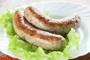 Image showing two sausages on plate