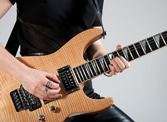 Image showing Female guitarist playing electric guitar