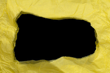 Image showing Yellow torn paper with black space