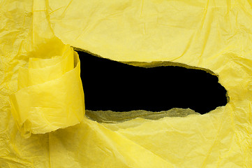 Image showing Yellow torn paper with black space