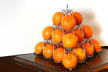 Image showing pyramid of oranges on a table