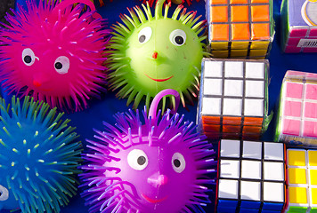 Image showing Rubik and rubber toys smile sold in outdoor fair. 