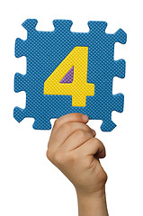 Image showing Children hand holding the number Four. White isolated number