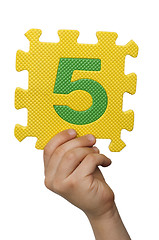 Image showing Children hand holding the number Five. White isolated number
