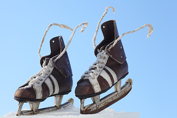 Image showing vintage pair of mens  skates on the ice