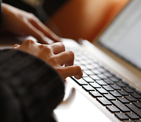 Image showing Young woman working on laptop