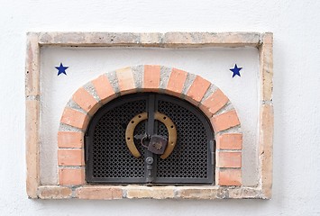Image showing Small ventilation window with grate, padlock and horseshoe