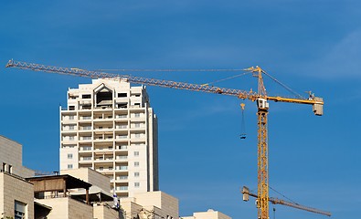 Image showing Lifting crane and apartment building under construction