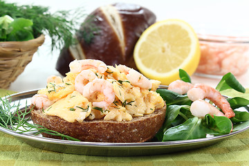 Image showing Scrambled eggs with shrimp and dill