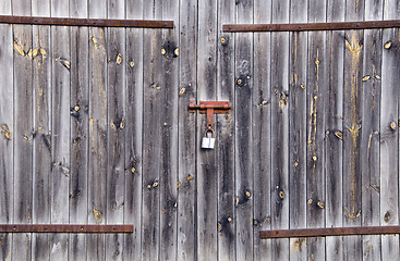 Image showing Old wooden farm rural building door locked padlock 