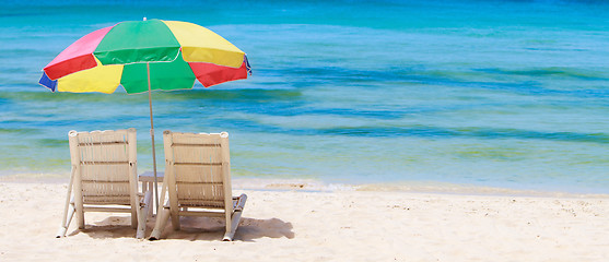 Image showing Panorama of tropical beach with chairs and umbrella