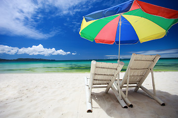 Image showing Two beach chairs and colorful umbrella