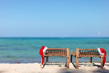 Image showing Two santa hats on sunbeds