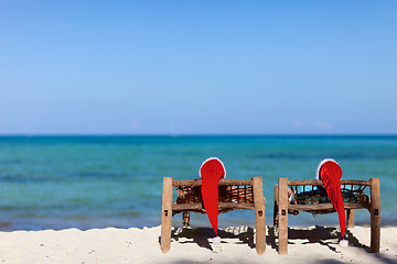 Image showing Couple in Santa hats on tropical beach