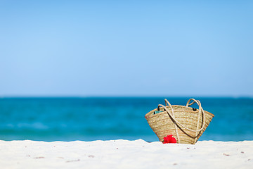 Image showing Straw beach bag on exotic white sand beach