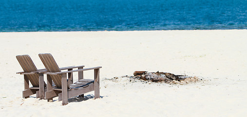 Image showing Wooden chairs at tropical beach panorama