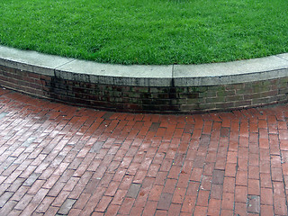 Image showing Brick Wall curving with grass lawn