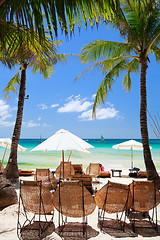 Image showing Wooden beach chairs on exotic beach