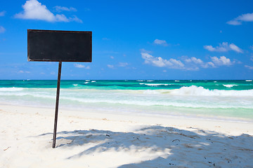 Image showing Blank blackboard display on tropical beach