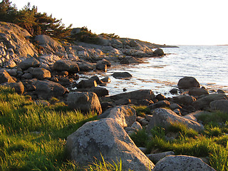 Image showing Rocky bay at sunset