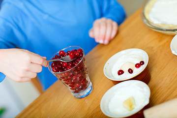 Image showing Boy baking cupcakes closeup