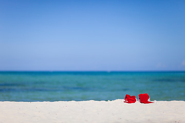 Image showing Two santa hats on beach