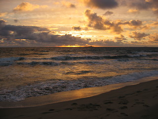 Image showing Sunset at Orre beach with an isle in the horizon