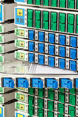 Image showing fiber optic rack with high density of blue and green SC connectors