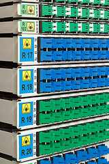 Image showing fiber optic rack with high density of blue and green SC connectors