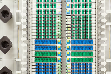 Image showing fiber optic rack with high density of blue and green SC connectors