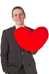 Image showing Handsome man with red heart shaped pillow