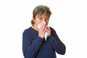 Image showing Senior woman blowing her nose 