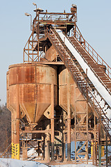 Image showing Belt conveyors and silos in a gravel pit in winter