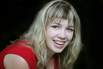 Image showing Smiling blond girl in red