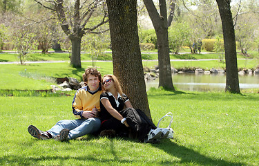 Image showing Romantic couple sitting in a park.