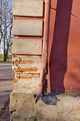 Image showing crumbling brick house corner wall rainwater pipe 