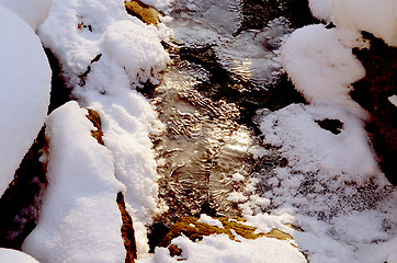 Image showing Snowy forest stream freeze ice snow background 