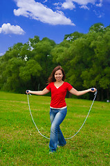 Image showing Young woman with skipping rope