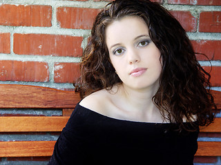 Image showing Beautiful young woman against brick wall