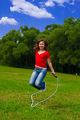 Image showing Young woman with skipping rope