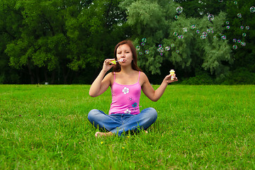 Image showing girl blowing soap bubbles