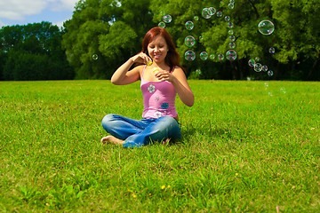 Image showing girl blowing soap bubbles