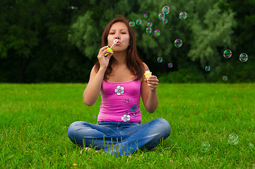 Image showing girl blowing soap bubbles