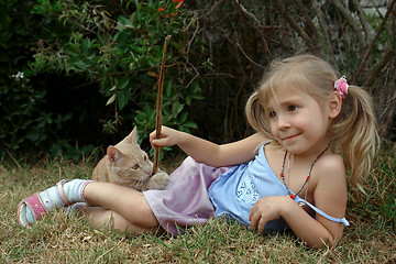 Image showing the child play with kitten