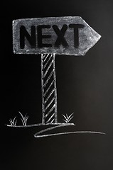 Image showing Signpost of next drawn in chalk on a blackboard